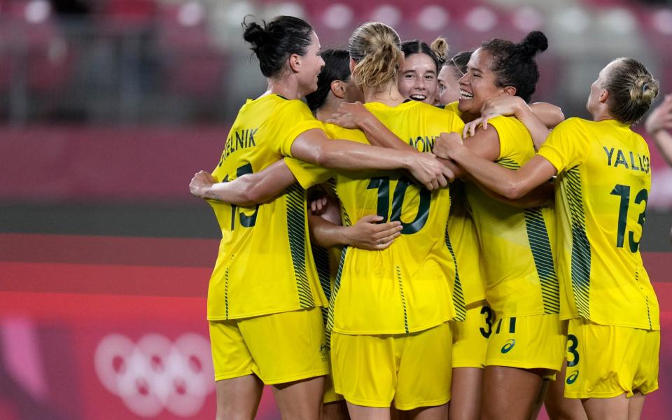 Australia celebrate their extra-time victory - AP