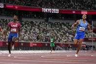 Lamont Jacobs, right, of Italy, celebrates after winning the men's the 100-meter final at the 2020 Summer Olympics, Sunday, Aug. 1, 2021, in Tokyo.(AP Photo/Petr David Josek)