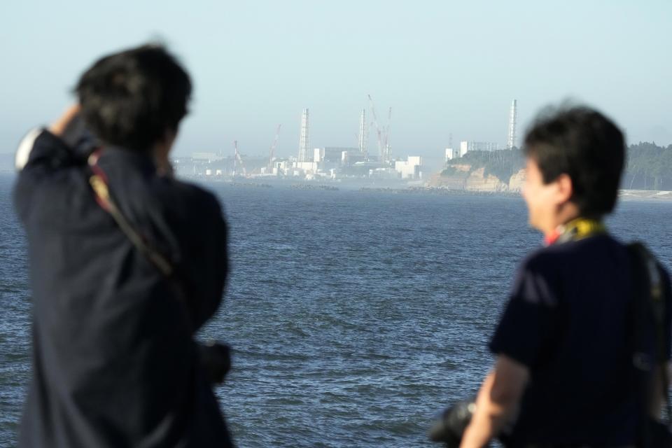 The Fukushima Daiichi nuclear power plant, damaged by a massive March 11, 2011, earthquake and tsunami, is seen from the nearby Ukedo fishing port in Namie town, northeastern Japan, Thursday, Aug. 24, 2023. The Fukushima Daiichi nuclear power plant will start releasing treated and diluted radioactive wastewater into the Pacific Ocean as early as Thursday. (AP Photo/Eugene Hoshiko)