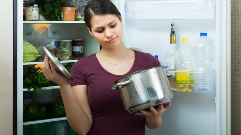 person looking into pot