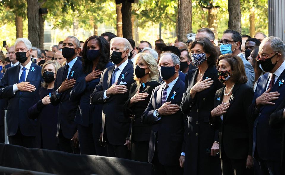 (L-R) Former President Bill Clinton, former First Lady Hillary Clinton, former President Barack Obama, former First Lady Michelle Obama, President Joe Biden, First Lady Jill Biden, former New York City Mayor Michael Bloomberg, Bloomberg's partner Diana Taylor, Speaker of the House Nancy Pelosi (D-CA) and Senate Minority Leader Charles Schumer (D-NY) stand for the national anthem during the annual 9/11 Commemoration Ceremony at the National 9/11 Memorial and Museum on September 11, 2021 in New York City.