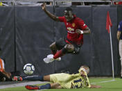 <p>Manchester United defender Eric Bailly, top, has the ball knocked away by Club America defender Luis Reyes (12) during the first half of a friendly soccer match at University of Phoenix Stadium, Thursday, July, 19, 2018, in Glendale Ariz. (AP Photo/Ralph Freso) </p>