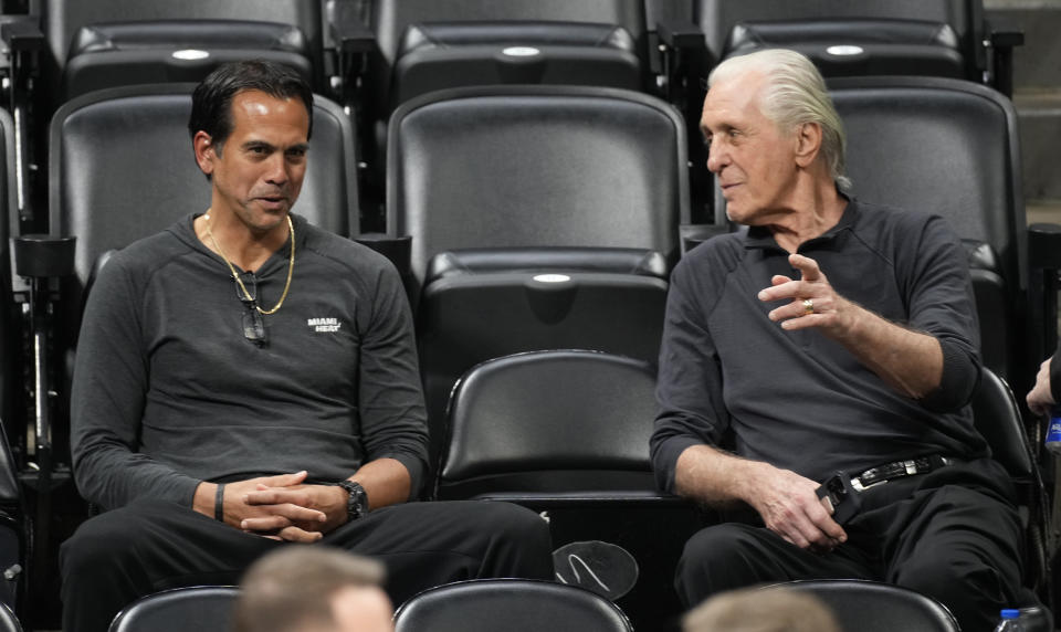 Miami Heat head coach Erik Spoelstra, left, chats with team president Pat Riley as they watch players practice for Game 2 of the NBA Finals, Saturday, June 3, 2023, in Denver. (AP Photo/David Zalubowski