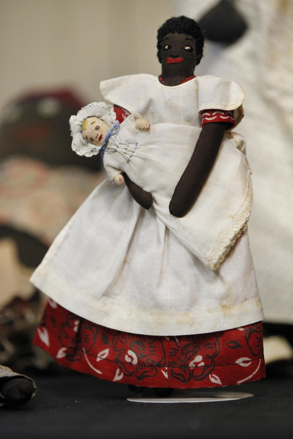 In this Wednesday, July 25, 2012 photo, historic black cloth dolls appear on display in New Orleans. Amid rare antique dolls crafted in porcelain, whimsical Kewpies and homage to contemporary icon Barbie, cloth dolls in the image of African-Americans drew special attention as more than 1,200 collectors gathered in New Orleans for the annual convention of the United Federation of Doll Clubs. (AP Photo/Gerald Herbert)