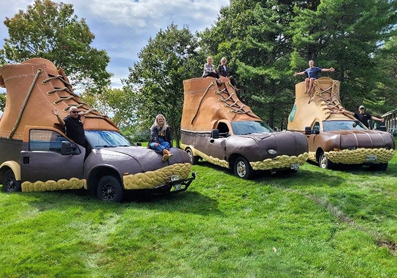 L.L. Bean Bootmobile drivers pose with the fleet of three Bootmobile vehicles, the first of which launched in 2012.