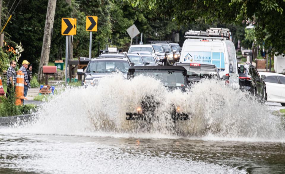 Vehicles make their way through flood waters on Old Yorktown Rd; in Shrub Oak, N.Y. July 10, 2023. Torrential storms Sunday evening led to flash flooding and at least one fatality in New YorkÕs Hudson Valley 