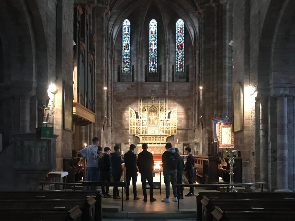 Students gather in remembrance of the four teenagers at Shrewsbury Abbey (The Independent)