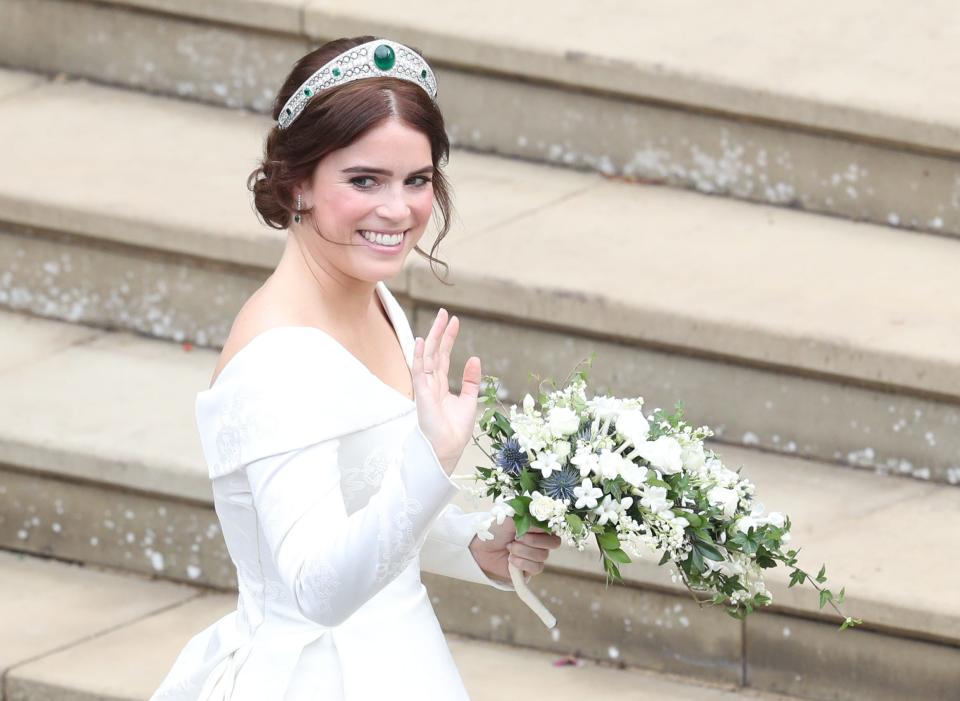 Princess Eugenie looks over her shoulder and waves on her wedding day in 2018.