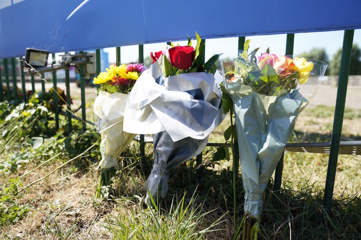 Flowers are left outside Liquid Leisure in Windsor, following the death of an 11-year-old girl (Andrew Matthews/PA) (PA Wire)