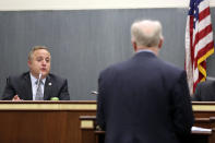 South Carolina state Rep. Russell Fry, R-Surfside Beach, left, asks a question to South Carolina Senior Assistant Deputy Attorney General Don Zelenka during a hearing, Wednesday, April 21, 2021, in Columbia, S.C. Zelenka was testifying about a bill that would add a firing squad to the state's execution methods. (AP Photo/Jeffrey Collins)