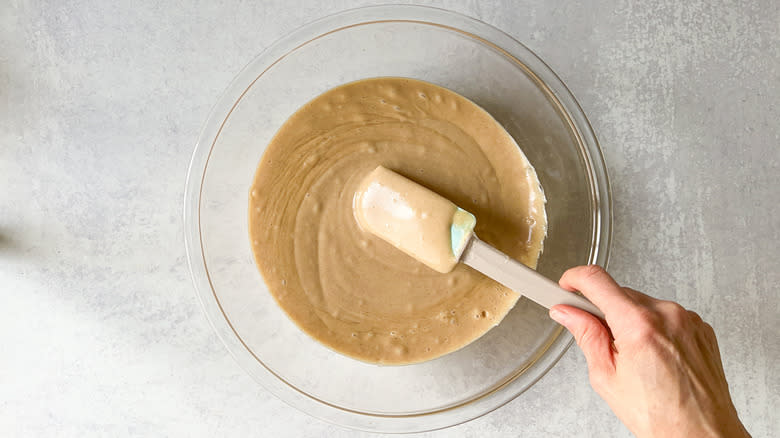 Vegan cinnamon-cashew frosting in bowl with spatula