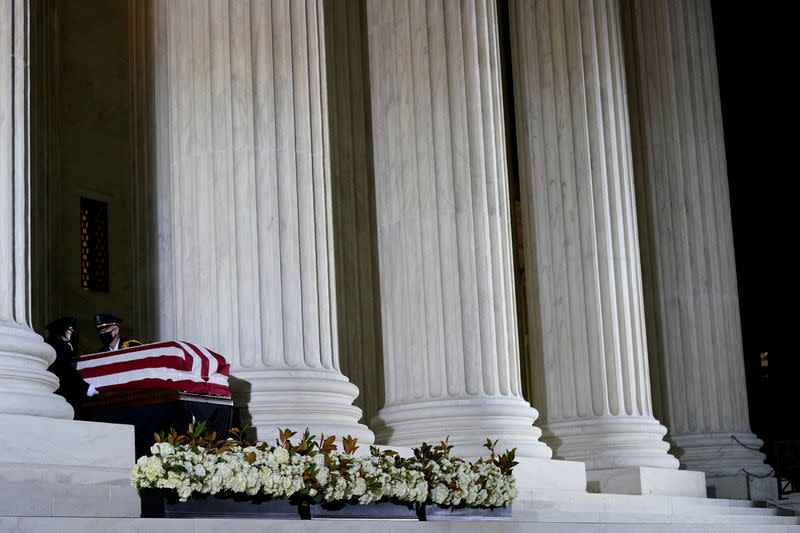 FILE PHOTO: Supreme Court Honor Guard moves the flag-draped casket of Justice Ginsburg back into the U.S. Supreme Court building in Washington