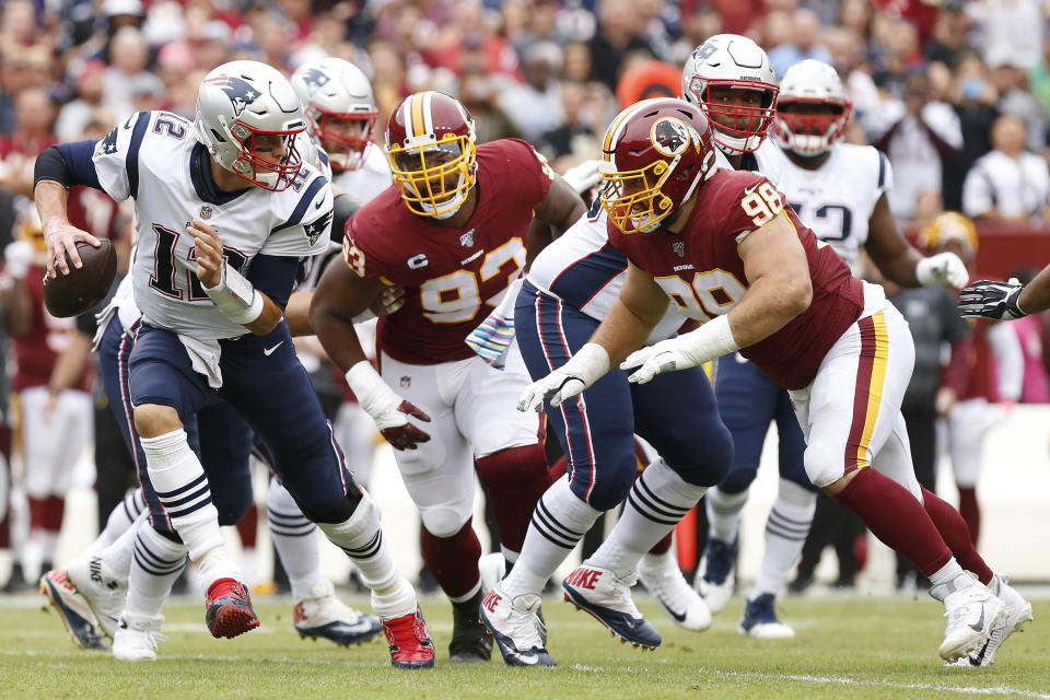 New England Patriots quarterback Tom Brady (12) scrambles from Washington Redskins defensive end Matthew Ioannidis (98). Mandatory Credit: Geoff Burke-USA TODAY Sports