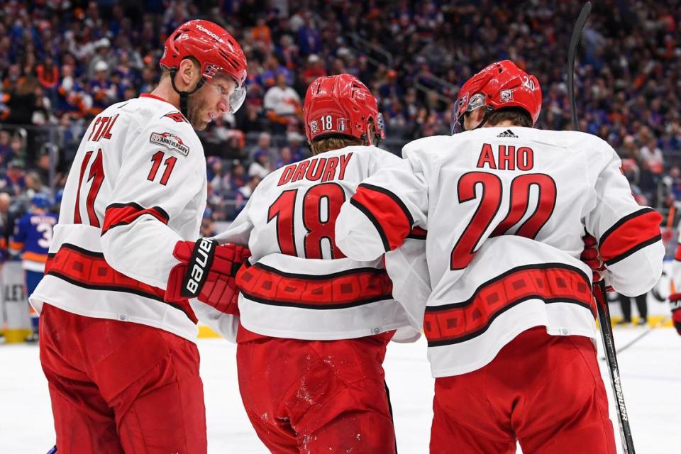 Apr 23, 2023; Elmont, New York, USA; Carolina Hurricanes center Jordan Staal (11) and Carolina Hurricanes center Sebastian Aho (20) help Carolina Hurricanes center Jack Drury (18) off the ice after an injury against the New York Islanders during the first period in game four of the first round of the 2023 Stanley Cup Playoffs at UBS Arena. Mandatory Credit: Dennis Schneidler-USA TODAY Sports Dennis Schneidler/Dennis Schneidler-USA TODAY Sports