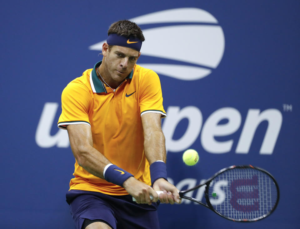 FILE - Juan Martin del Potro, of Argentina, returns a shot to Novak Djokovic, of Serbia, during the men's final of the U.S. Open tennis tournament, Sunday, Sept. 9, 2018, in New York. Juan Martín del Potro tells The Associated Press he would love to play at the U.S. Open this year if his body will allow it. That was the site of his biggest Grand Slam triumph — he beat Rafael Nadal and Roger Federer en route to the 2009 title in New York. (AP Photo/Adam Hunge, File)