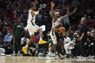 Milwaukee Bucks guard Rodney Hood and center DeMarcus Cousins force Miami Heat guard Gabe Vincent (2) to pass the ball during the first half of an NBA basketball game, Wednesday, Dec. 8, 2021, in Miami. (AP Photo/Marta Lavandier)