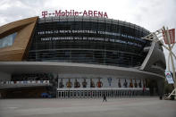 A sign at T-Mobile Arena advertises the cancellation of the Pac-12 men's basketball tournament amid coronavirus fears Thursday, March 12, 2020, in Las Vegas. The vast majority of people recover from the new virus. According to the World Health Organization, people with mild illness recover in about two weeks, while those with more severe illness may take three to six weeks to recover. (AP Photo/John Locher)