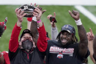 Ohio State head coach Ryan Day, left, holds the trophy along side running back Trey Sermon after defeating Northwestern in the Big Ten championship NCAA college football game, Saturday, Dec. 19, 2020, in Indianapolis. Ohio State won 22-10. (AP Photo/Darron Cummings)