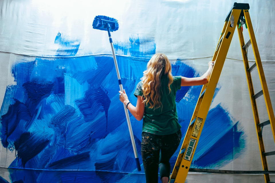 Artist Alexa Meade paints a wall her signature shades of colbalt blue. 