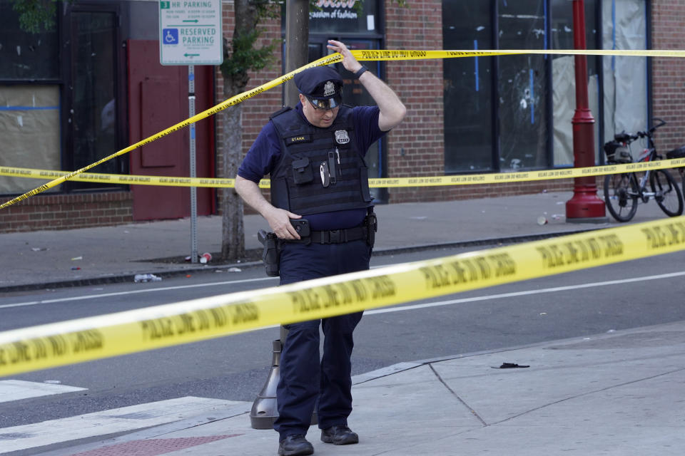 Philadelphia Police investigators work the scene of a fatal overnight shooting on South Street in Philadelphia, Sunday, June 5, 2022. 