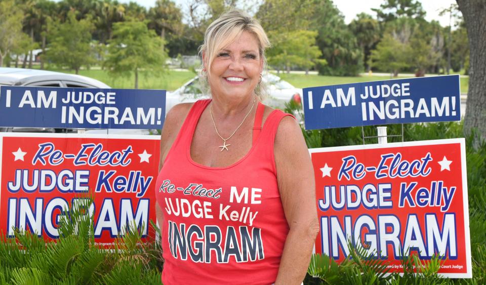 Judge Kelly Ingram is surrounded by signs at Fred Poppe Regional Park in Palm Bay. The incumbent, she is running in the race for county judge, Group 2.