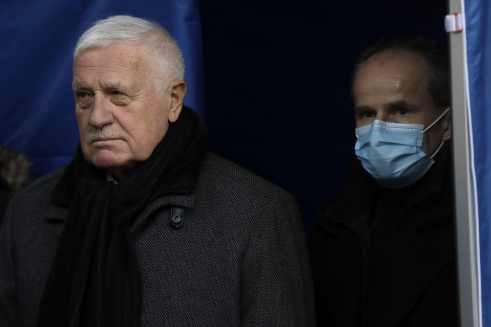 In this photo taken Sunday, Jan. 10, 2021, former Czech Republic's President Vaclav Klasu attends a protest against the government's restrictive measures imposed to contain the coronavirus pandemic at the Old Town Square in Prague, Czech Republic. Across the Balkans and the rest of the nations in the southeastern corner of Europe, a vaccination campaign against the coronavirus is overshadowed by heated political debates or conspiracy theories that threaten to thwart the process. In countries like the Czech Republic, Serbia, Bosnia, Romania and Bulgaria, skeptics have ranged from former presidents to top athletes and doctors. Nations that once routinely went through mass inoculations under Communist leaders are deeply split over whether to take the vaccines at all. (AP Photo/Petr David Josek)