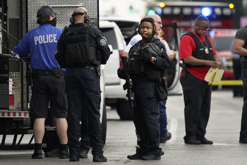 Police work near the scene of a shooting Saturday, Aug. 29, 2020, in St. Louis. The St. Louis Police Department says two of their officers have been shot and a suspect is believed to be barricaded in a house nearby. (AP Photo/Jeff Roberson)