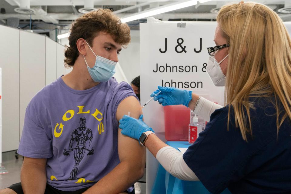 Bradley Sharp of Saratoga, N.Y., gets the Johnson & Johnson vaccine from registered nurse Stephanie Wagner on July 30, 2021, in New York. Sharp needs the vaccination because it is required by his college. Hundreds of college campuses told students they had to be fully vaccinated against COVID-19 before classes began in Fall 2021.