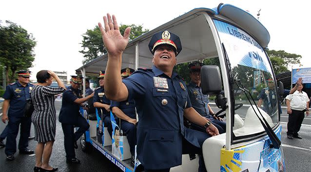 Philippine National Police chief, Ronald dela Rosa, waves before boarding a vehicle at Camp Crame police headquarters in suburban Quezon city on September 5. Photo: AP