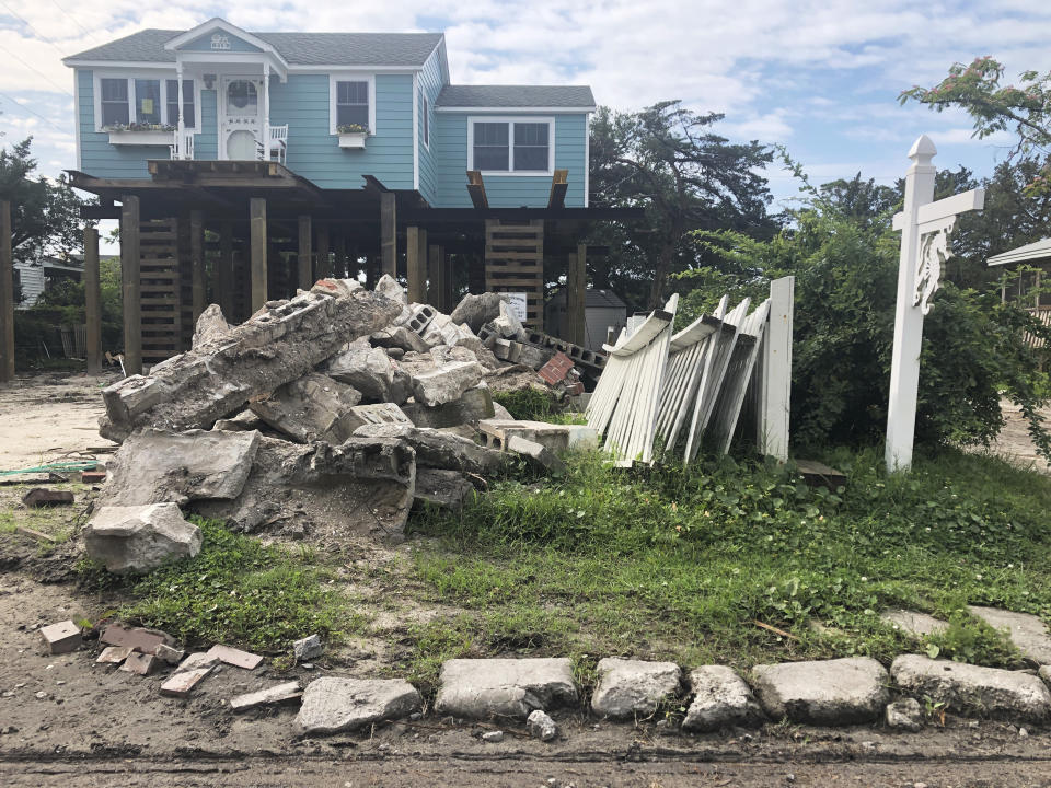 A house is being raised on Ocracoke Island in Ocracoke, N.C., Thursday, June 25, 2020. The secluded travel destination was ravaged by Hurricane Dorian in September and then hit with coronavirus-related travel restrictions in the spring. Residents and business owners are hoping to recoup some of their losses as tourists return, albeit in smaller than usual numbers. (AP Photo/Ben Finley)