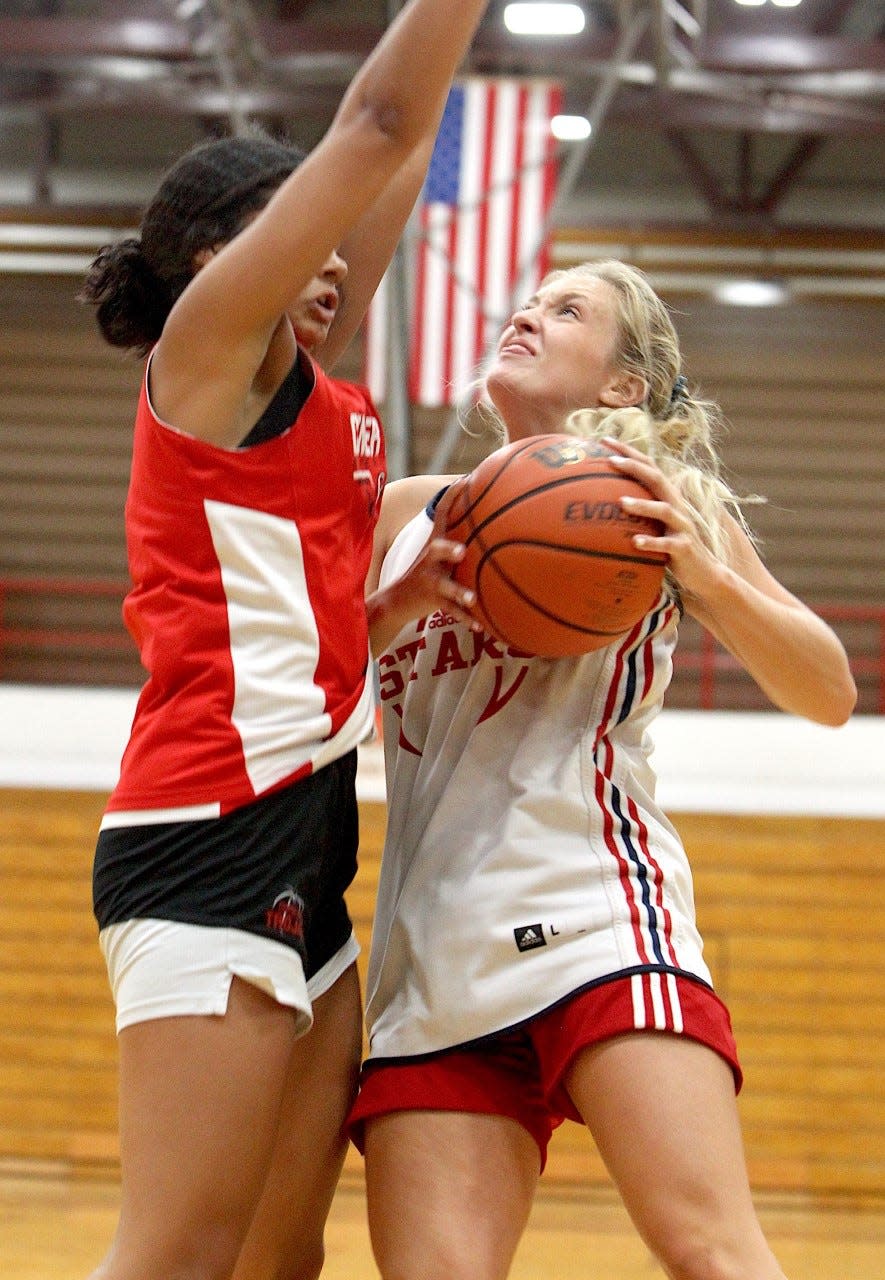 BNL senior Mallory Pride goes up inside against Center Grove's Aubrie Booker Thursday in summer action at BNL Fieldhouse. Pride was in double figures in rebounds.