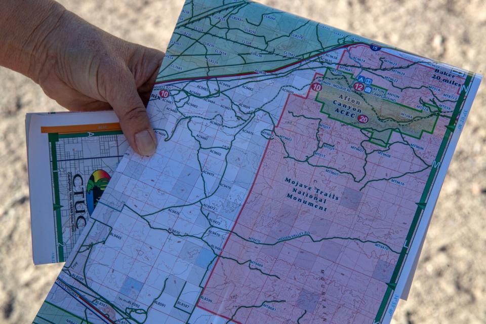 A hand holds a partly folded map of Mojave Trails National Monument.