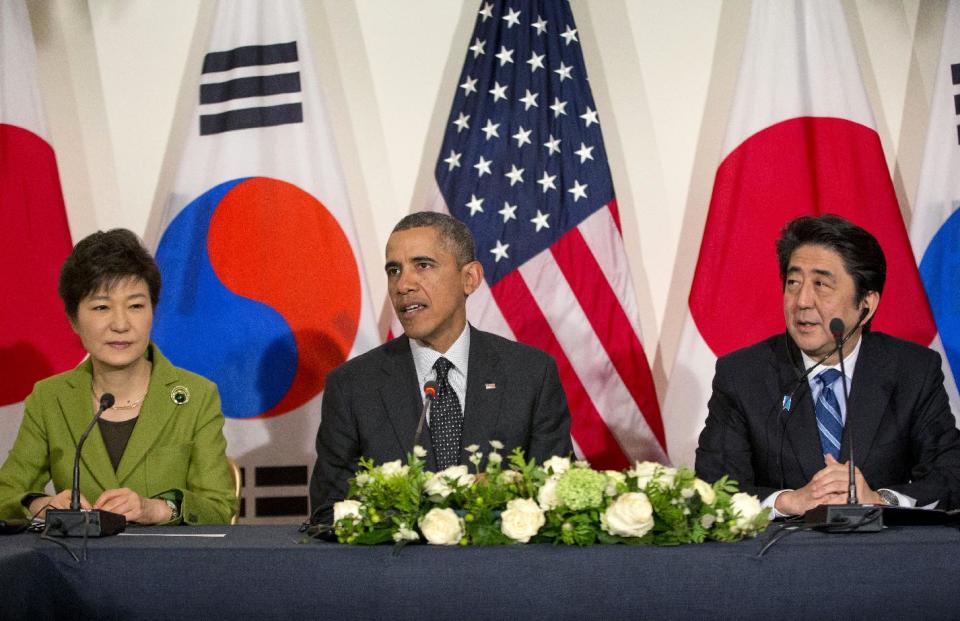 US President Barack Obama meets with Japanese Prime Minister Shinzo Abe, right, and South Korean President Park Geun-hye, Tuesday, March 25, 2014, at the US Ambassador's Residence in the Hague, Netherlands. (AP Photo/Pablo Martinez Monsivais)