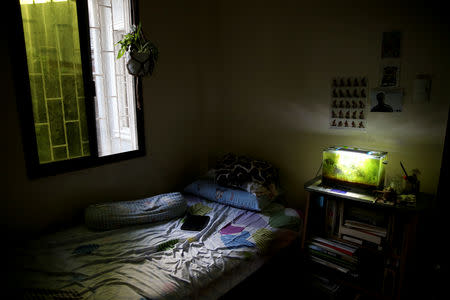 An aquarium glows in the bedroom of Oliver Emocling, 23, who works for a magazine, at his family home in Malabon City, Metro Manila, Philippines, October 15, 2018. REUTERS/Eloisa Lopez