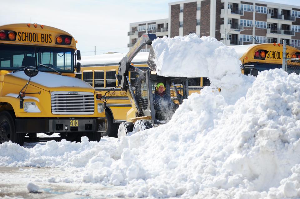 Scott Goedde, Evansville Vanderburgh School Corporation maintenance crew, helps clear the EVSC school transfer lot on  Thursday, March 5, 2015. Maintenance crews had to move all the busses and clear the lots as well as each school's on Thursday. Crews started at 6 a.m. and will work until 8 a.m to get lots and sidewalks clear for each school building.  So far this winter, EVSC has missed six school days this year. 