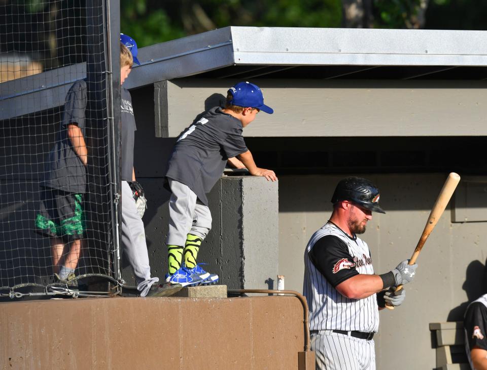 Little Leaguers talk to players in the Sartell Stone Poneys dugout between innings during the game against the Sartell Muskies Wednesday, June 29, 2022, at St. Cloud Orthopedics Field in Sartell. 