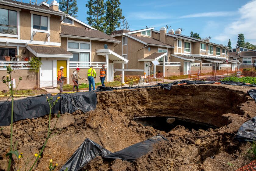 LA HABRA, CA - MARCH 17: Collapsed storm drain channel between condominiums at Coyote Village on Friday, March 17, 2023 in La Habra, CA. (Irfan Khan / Los Angeles Times)