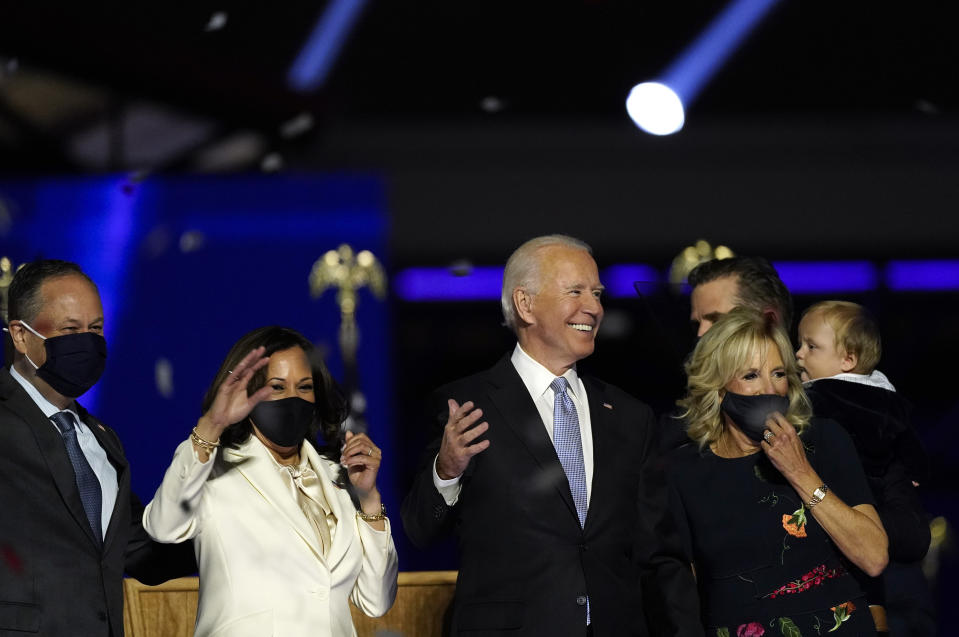 President-elect Joe Biden, his wife Jill Biden, and members of the Biden family, along with Vice President-elect Kamala Harris, her husband Doug Emhoff stand on stage Saturday, Nov. 7, 2020, in Wilmington, Del. (AP Photo/Andrew Harnik)