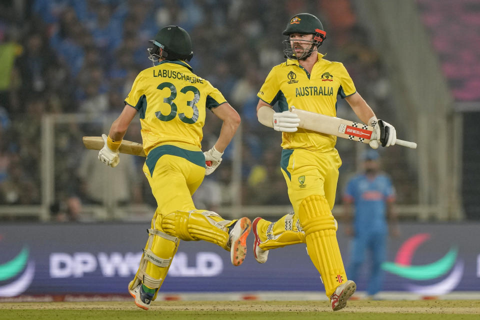 Australia's Travis Head, right, and Marnus Labuschagne run between the wickets during the ICC Men's Cricket World Cup final match between Australia and India in Ahmedabad, India, Sunday, Nov.19, 2023. (AP Photo/Mahesh Kumar A.)