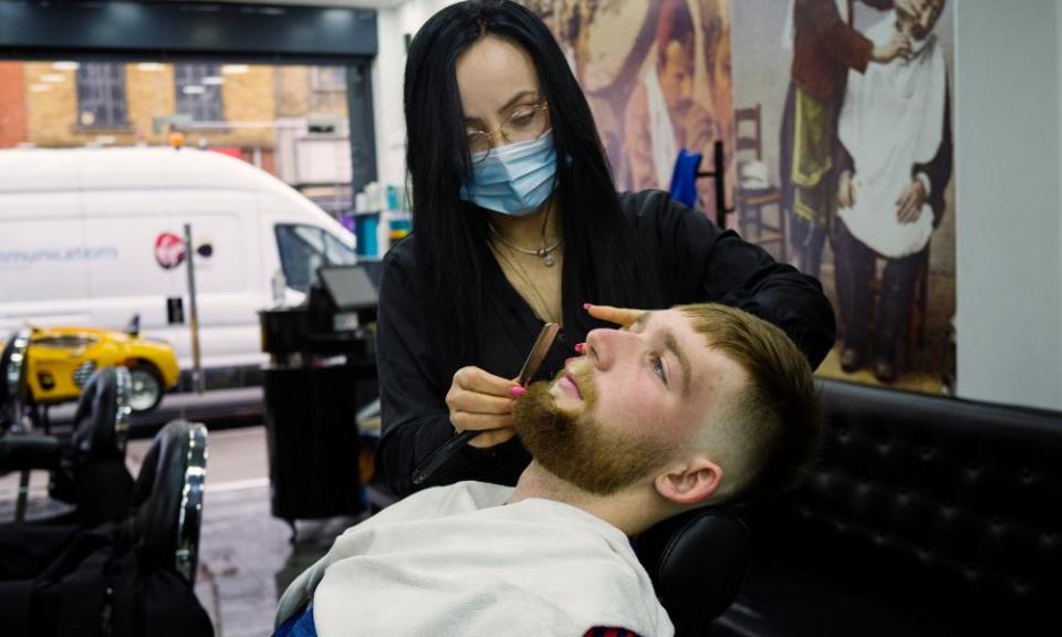 JP Lombard removes his mask to get his beard trimmed at the Barber Line Turkish barbers in Camden but otherwise says he is happy to wear one.