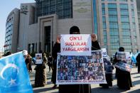 Ethnic Uyghur women take part in a protest against China