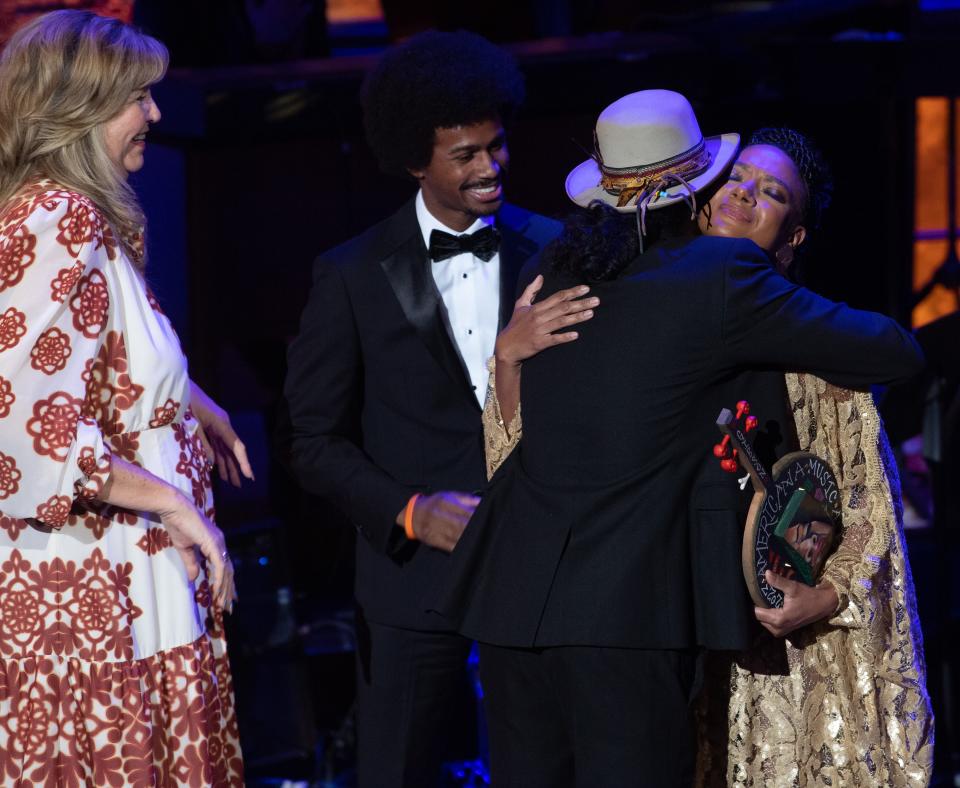 Allison Russell is hugged by Justin Jones, D-Nashville, as she accepts the Spirit of Americana Award during the Americana Music Association Awards and Honors at the Ryman Auditorium in Nashville, Tenn., Wednesday, Sept. 20, 2023.