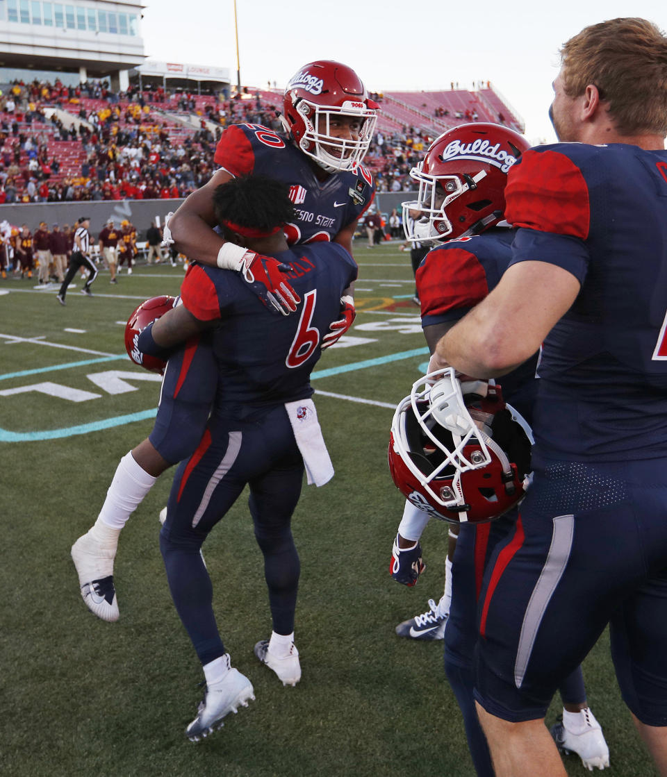 Fresno State defensive back Anthoula Kelly (6) holds up game MVP running back Ronnie Rivers (20) after they defeated Arizona State in the Las Vegas Bowl NCAA college football game, Saturday, Dec. 15, 2018, in Las Vegas. Fresno State won 31-20. (AP Photo/John Locher)