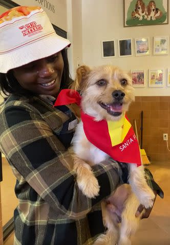 <p>Santa Fe Animal Shelter/Facebook</p> Panfilo the dog with back with his owner Roughiatou at the Santa Fe Animal Shelter & Humane Society