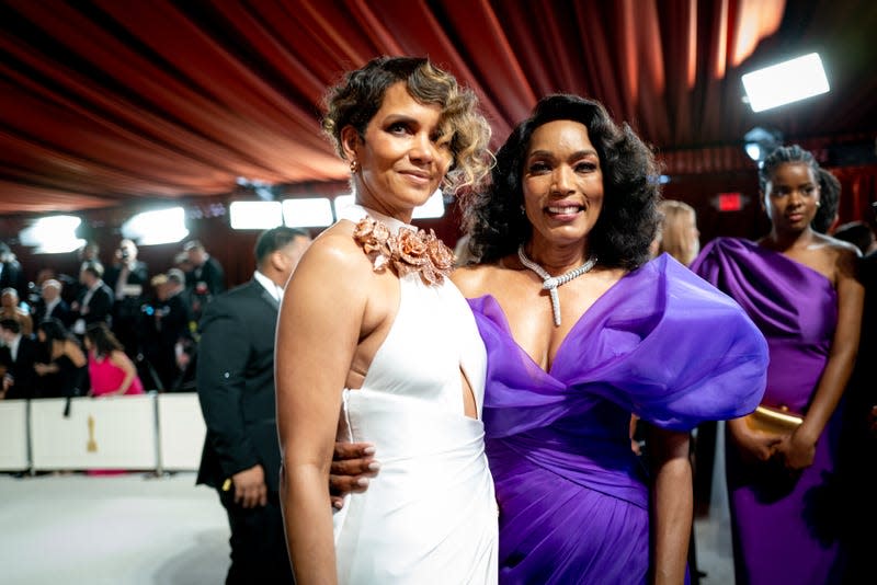 HOLLYWOOD, CALIFORNIA - MARCH 12: (L-R) Halle Berry and Angela Bassett attend the 95th Annual Academy Awards at Hollywood & Highland on March 12, 2023 in Hollywood, California. 