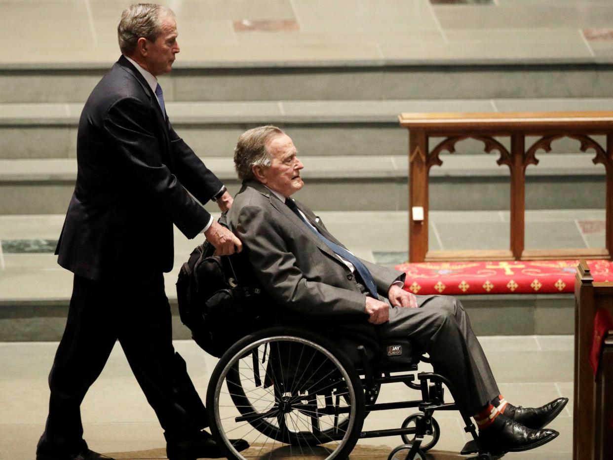 Former president George HW Bush is pushed by his son, former president George W Bush, during funeral services for former first lady Barbara Bush in Houston, Texas: David J. Phillip/Pool via Reuters