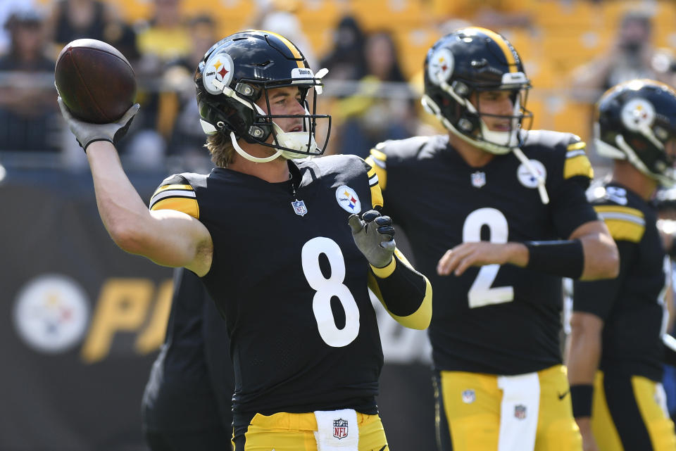 Pittsburgh Steelers quarterbacks Kenny Pickett (8) and Mason Rudolph (2) warm up before an NFL preseason football game against the Detroit Lions, Sunday, Aug. 28, 2022, in Pittsburgh. (AP Photo/Don Wright)