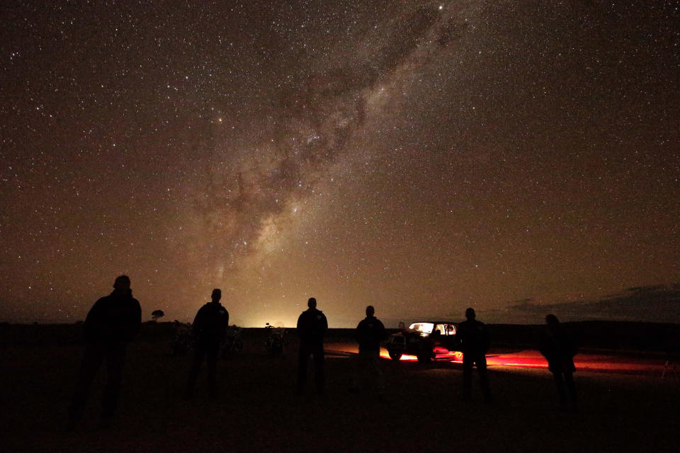 In this May 28, 2013 photo, tourists stand and gaze at the milky-way near Broken Hill, 1,160 kilometers (720 miles) from Sydney, Australia, during a seven-day, 3,000-kilometer (1,900-mile) journey across the Outback. (AP Photo/Rob Griffith)