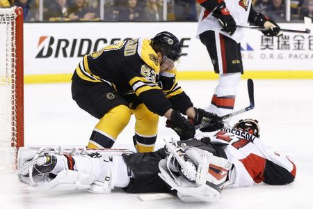 Apr 23, 2017; Boston, MA, USA; Boston Bruins left wing Brad Marchand (63) battles with Ottawa Senators goalie Craig Anderson (41) during the overtime period of game six of the first round of the 2017 Stanley Cup Playoffs at TD Garden. The Senators won 3-2 in overtime. Mandatory Credit: Greg M. Cooper-USA TODAY Sports