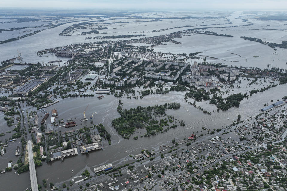 Houses are seen underwater and polluted by oil in a flooded neighbourhood in Kherson, Ukraine, Saturday, June 10, 2023. The destruction of the Kakhovka Dam in southern Ukraine is swiftly evolving into long-term environmental catastrophe. It affects drinking water, food supplies and ecosystems reaching into the Black Sea. (AP Photo)